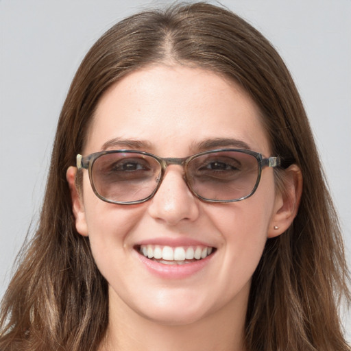 Joyful white young-adult female with long  brown hair and blue eyes