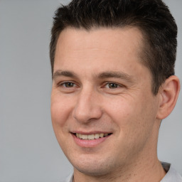 Joyful white adult male with short  brown hair and brown eyes