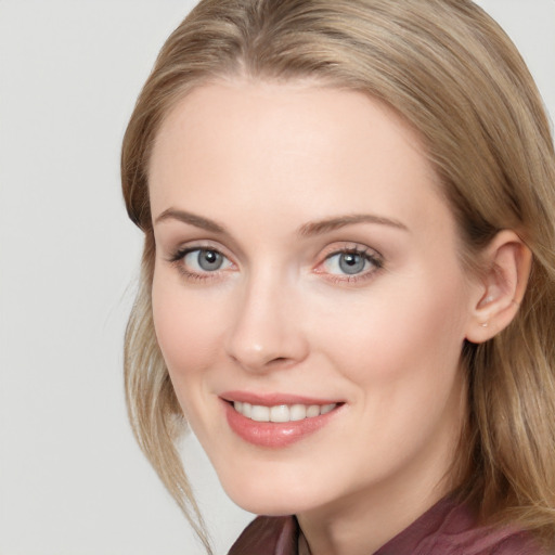 Joyful white young-adult female with long  brown hair and blue eyes