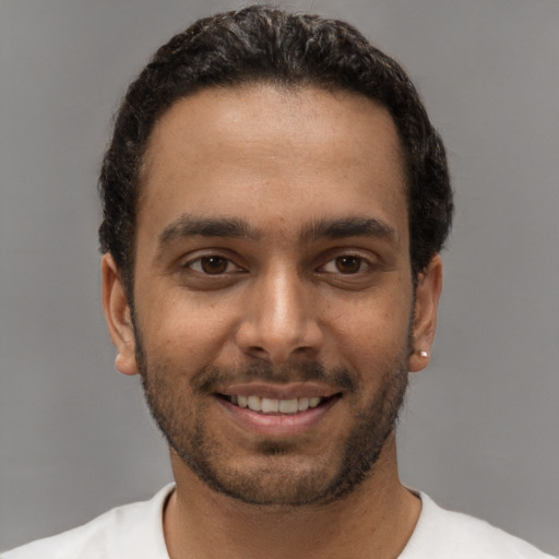 Joyful white young-adult male with short  black hair and brown eyes
