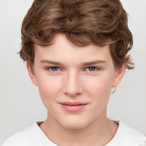 Joyful white child male with short  brown hair and grey eyes