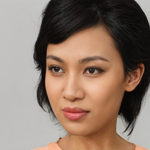 Joyful latino young-adult female with medium  black hair and brown eyes