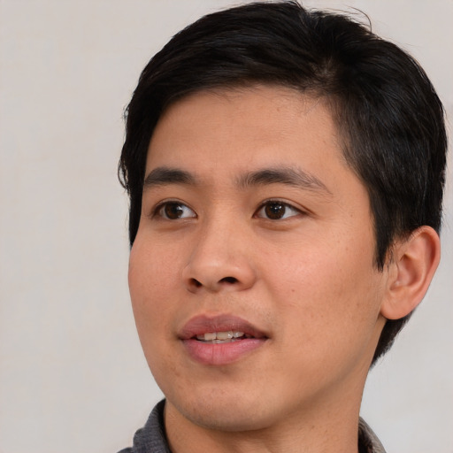 Joyful asian young-adult male with short  brown hair and brown eyes