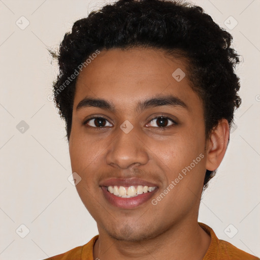 Joyful latino young-adult male with short  brown hair and brown eyes