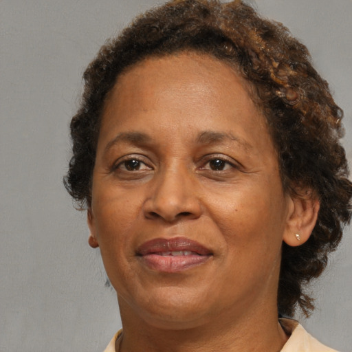 Joyful black adult female with medium  brown hair and brown eyes
