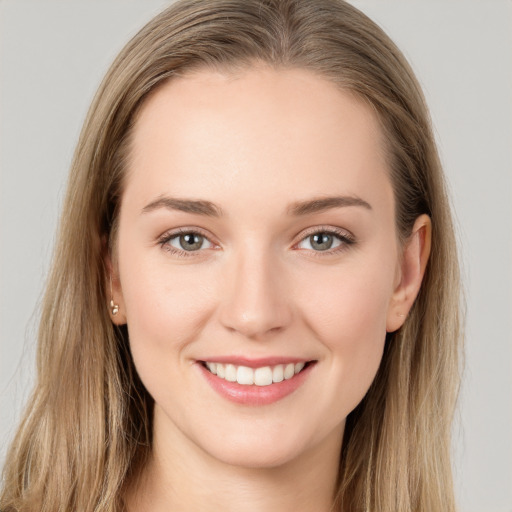 Joyful white young-adult female with long  brown hair and grey eyes