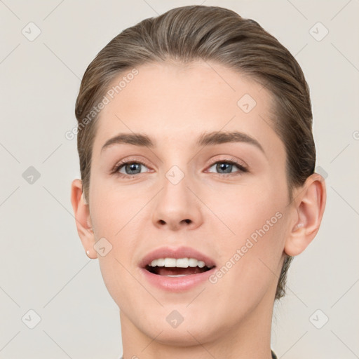 Joyful white young-adult female with short  brown hair and grey eyes