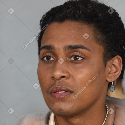 Joyful black young-adult male with short  black hair and brown eyes
