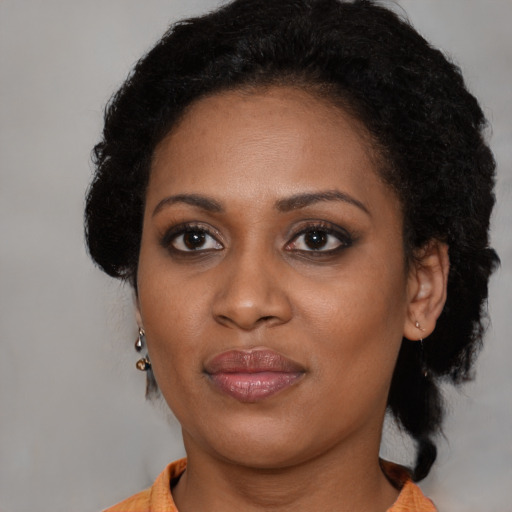 Joyful black young-adult female with medium  brown hair and brown eyes