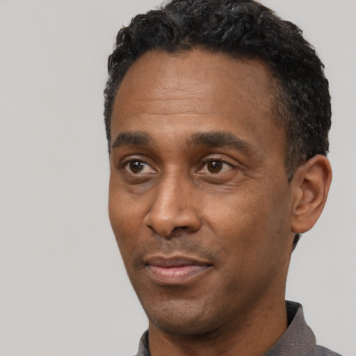 Neutral black adult male with short  black hair and brown eyes