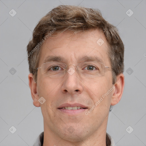 Joyful white adult male with short  brown hair and grey eyes