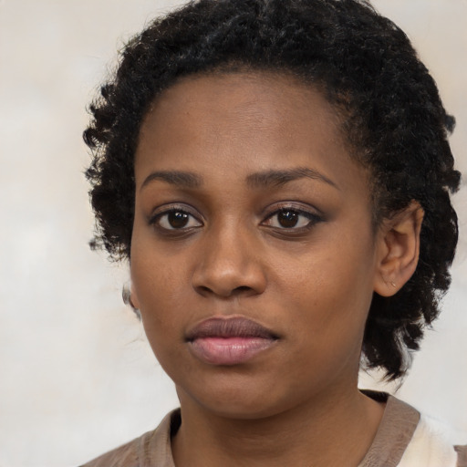 Neutral black young-adult female with medium  brown hair and brown eyes