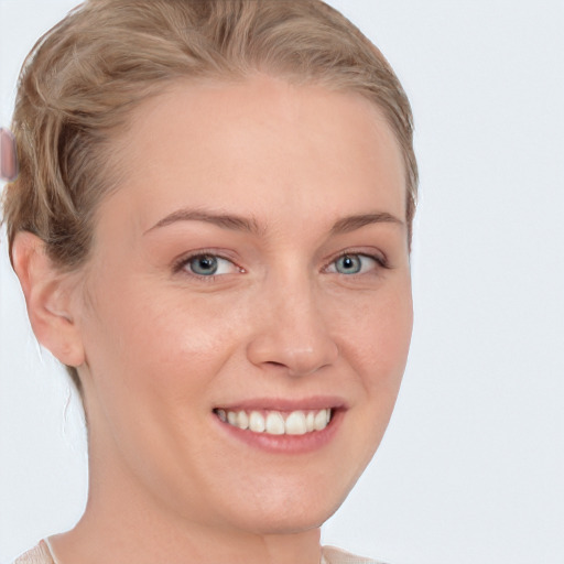 Joyful white young-adult female with short  brown hair and blue eyes