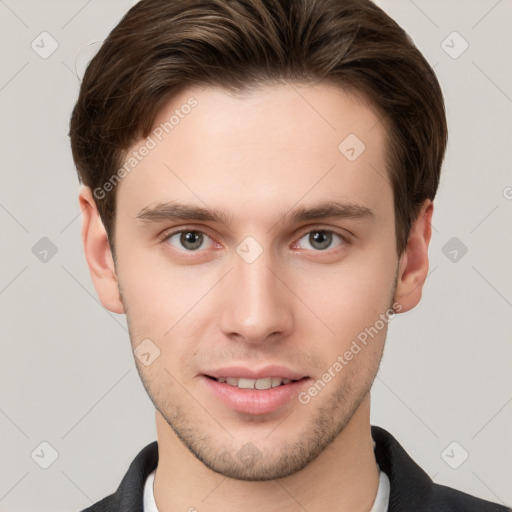 Joyful white young-adult male with short  brown hair and grey eyes