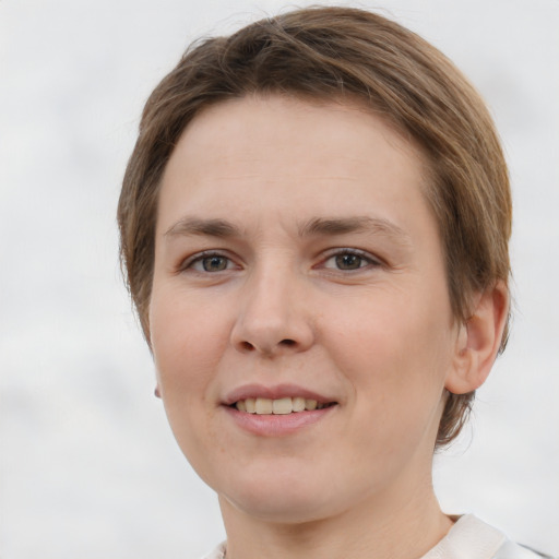 Joyful white young-adult female with short  brown hair and grey eyes