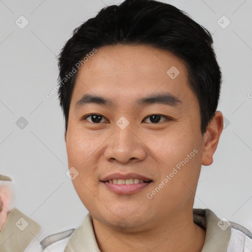 Joyful asian young-adult male with short  black hair and brown eyes
