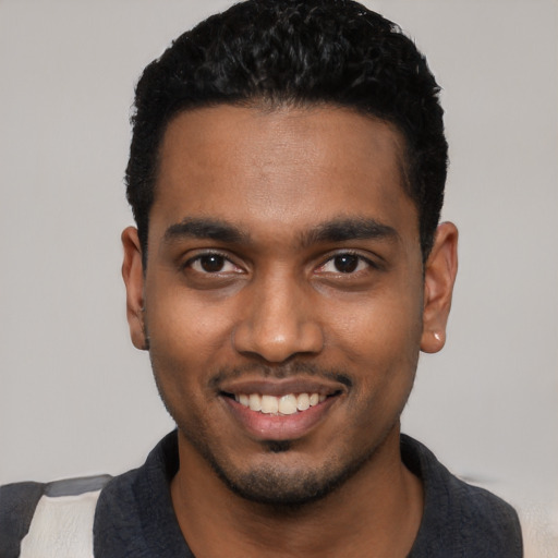 Joyful black young-adult male with short  black hair and brown eyes