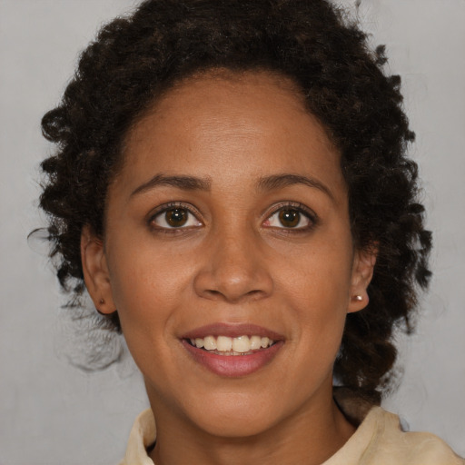 Joyful black young-adult female with medium  brown hair and brown eyes