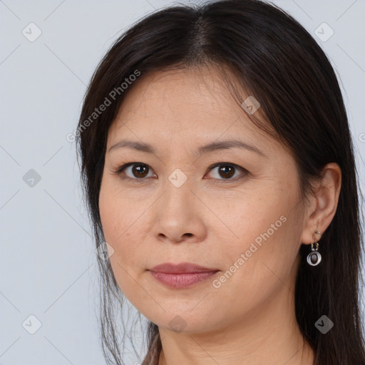 Joyful white adult female with long  brown hair and brown eyes