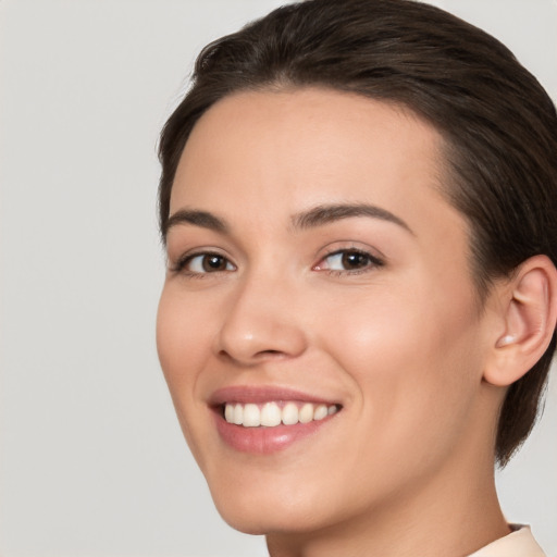 Joyful white young-adult female with medium  brown hair and brown eyes