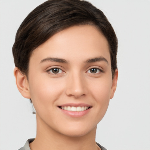 Joyful white young-adult female with short  brown hair and brown eyes