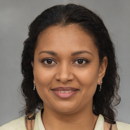 Joyful black young-adult female with medium  brown hair and brown eyes