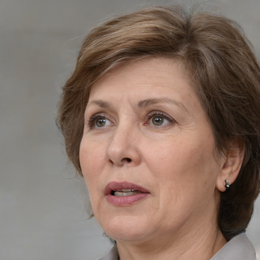 Joyful white adult female with medium  brown hair and grey eyes