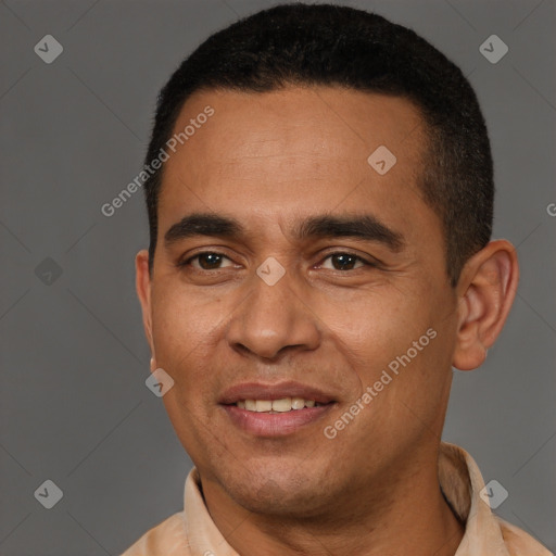 Joyful latino adult male with short  brown hair and brown eyes