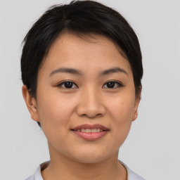 Joyful asian young-adult female with short  brown hair and brown eyes