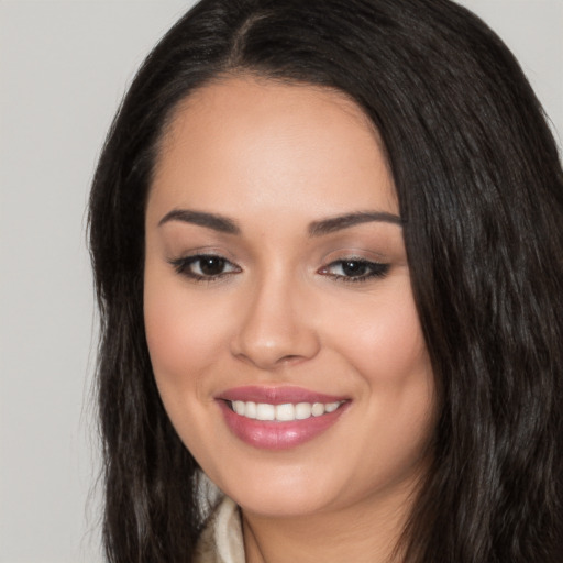 Joyful white young-adult female with long  black hair and brown eyes