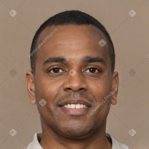 Joyful black young-adult male with short  brown hair and brown eyes