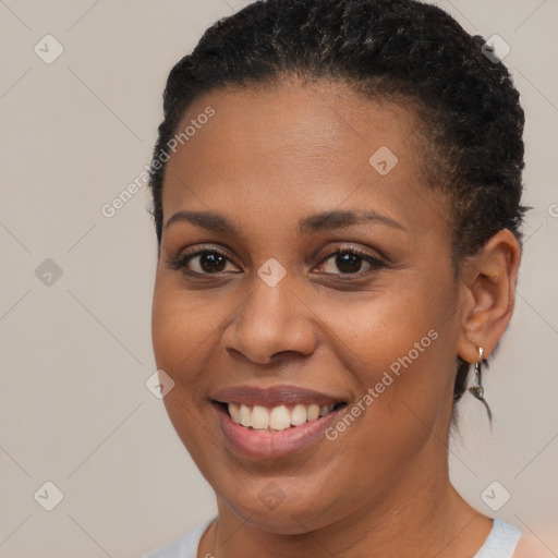 Joyful black young-adult female with short  brown hair and brown eyes