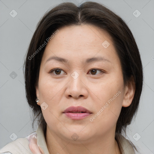 Joyful white adult female with medium  brown hair and brown eyes