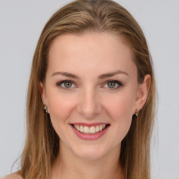 Joyful white young-adult female with long  brown hair and green eyes