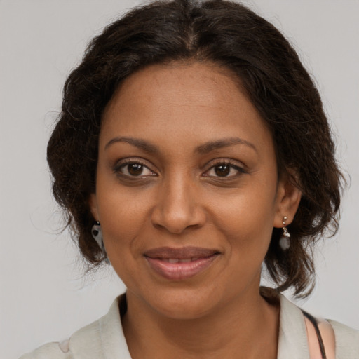 Joyful black young-adult female with medium  brown hair and brown eyes