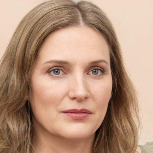 Joyful white young-adult female with long  brown hair and green eyes