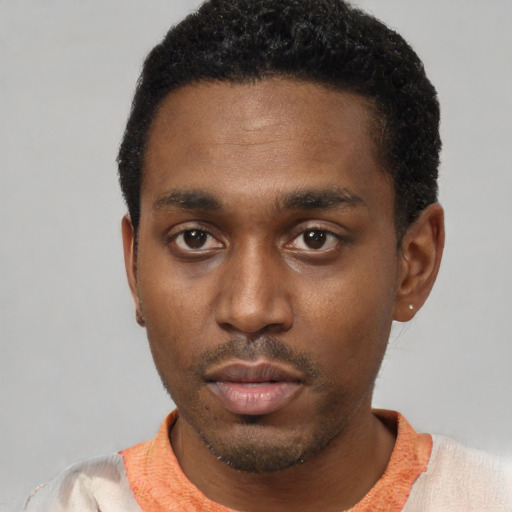Neutral latino young-adult male with short  black hair and brown eyes