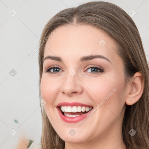 Joyful white young-adult female with long  brown hair and grey eyes