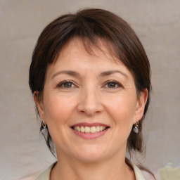 Joyful white adult female with medium  brown hair and brown eyes