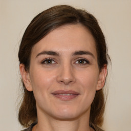 Joyful white young-adult female with medium  brown hair and brown eyes