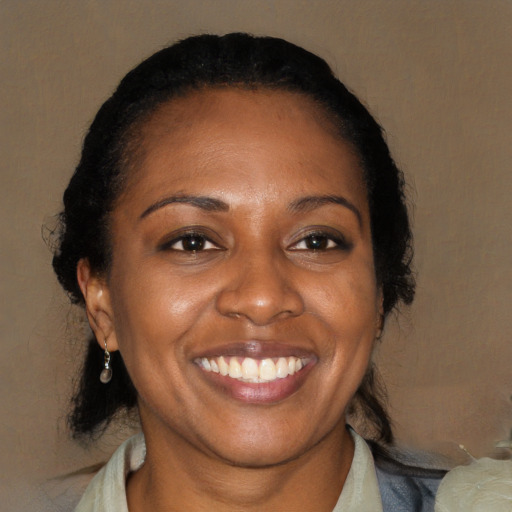 Joyful black young-adult female with medium  brown hair and brown eyes