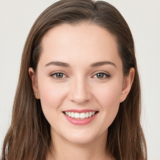 Joyful white young-adult female with long  brown hair and grey eyes