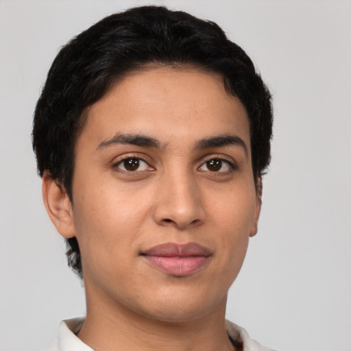 Joyful latino young-adult female with short  black hair and brown eyes