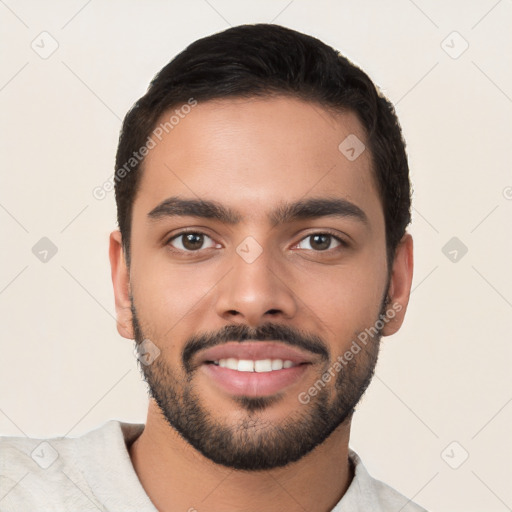 Joyful white young-adult male with short  black hair and brown eyes