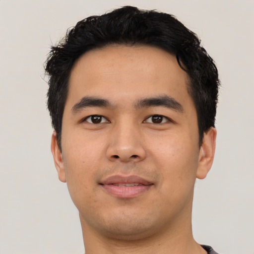 Joyful asian young-adult male with short  black hair and brown eyes