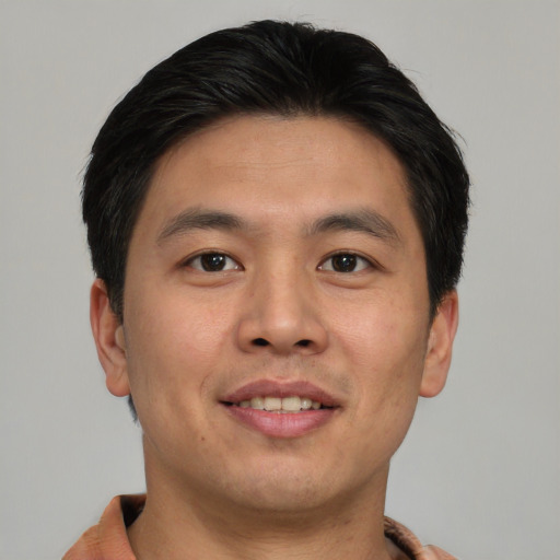 Joyful asian young-adult male with short  brown hair and brown eyes