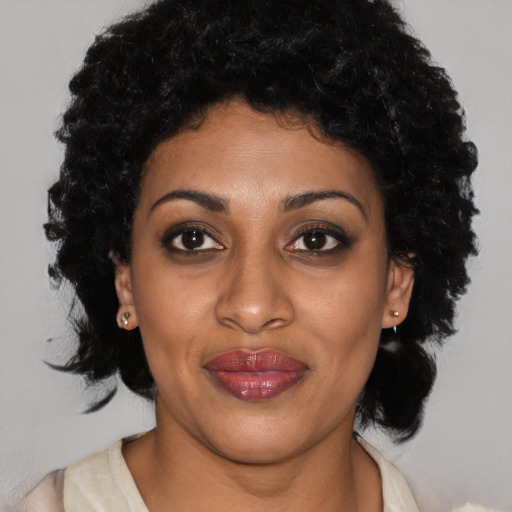 Joyful latino young-adult female with medium  black hair and brown eyes