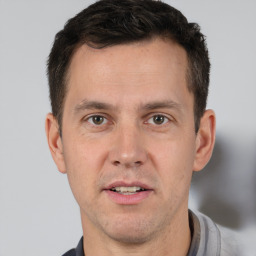 Joyful white adult male with short  brown hair and brown eyes