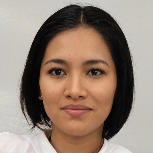 Joyful latino young-adult female with medium  black hair and brown eyes
