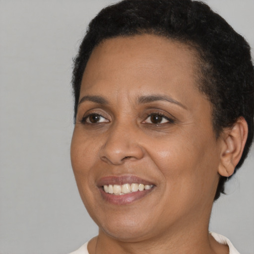 Joyful black young-adult female with short  brown hair and brown eyes